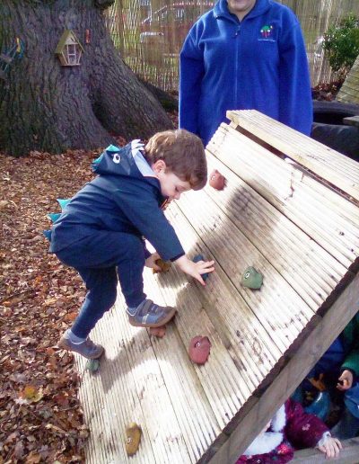 Oakwood Community Pre-school | Gallery | Child climbing the climbing frame