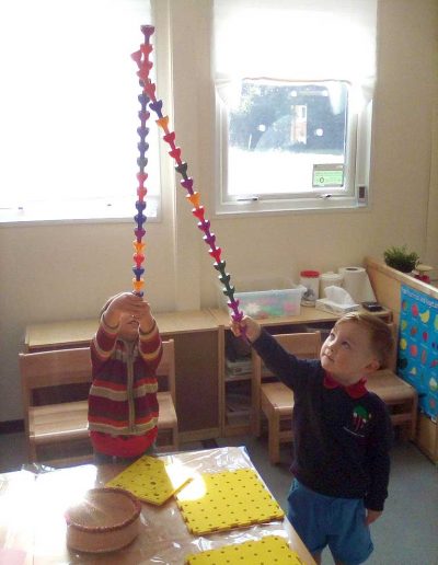Oakwood Community Pre-school | Gallery | Children building a single tower of pegs