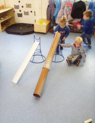 Oakwood Community Pre-school | Gallery | Children using tubes indoors